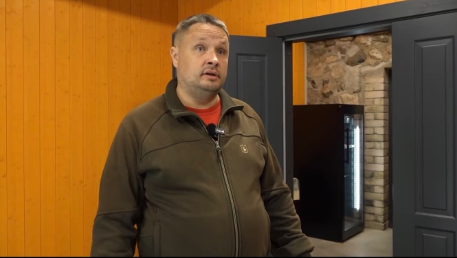 Attēlā redzams vīrietis, kurš runā kamerā