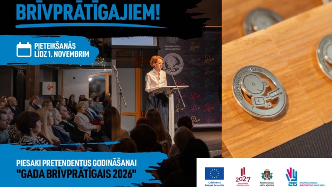 Attēlā redzami cilvēki zālē, kas sēž un klausās uzrunu